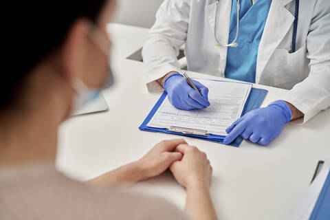 Medical professional prescribing new treatment to patient stock photo