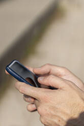 Close-up of businessman using smart phone outdoors - BOYF01800