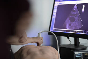 A doctor performs ultrasound on a teaching dummy - CAVF92870