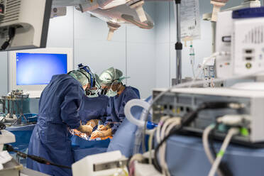 Two cardiac surgeons operate on a patient - CAVF92883