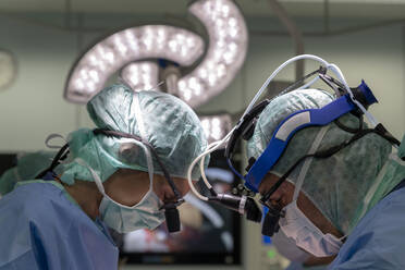 Two cardiac surgeons operating on a patient - CAVF92911