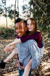 Brother & Sister Piggy Back at Park in Chula Vista - CAVF92955