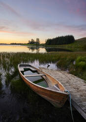 Sunken boat and quay in calm pond in evening - CAVF92993