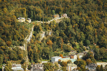 Austria, Salzburg, Aerial view of houses along forested mountain ridge - MRRF00888