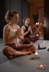 Women meditating with clasped hands - CAVF93211