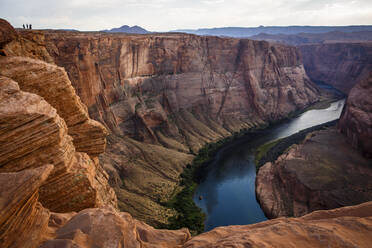 Hikers at Horseshoe Bend, part of the Colorado River near Page, AZ. - CAVF93252