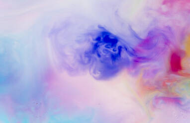 Full frame of blue, purple and red liquids mixing together - GEMF04659