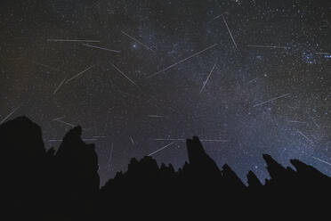 Geminids Meteor Shower over the Galayos granite spikes mountain peaks, Winter, Gredos, Avila, Spain - CAVF93435