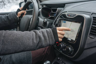 Man using navigational map while sitting in car - VPIF03513