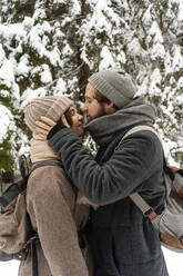 Young man doing romance with woman whiles standing in forest - VPIF03526