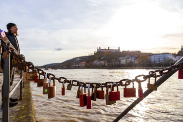 Love padlocks hanging on Main river against sky - NDF01253