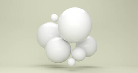 Three dimensional render of white bubbles floating against green background stock photo