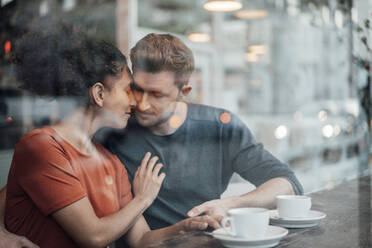 Paar sitzt mit geschlossenen Augen in einem Café von Angesicht zu Angesicht - JOSEF03572