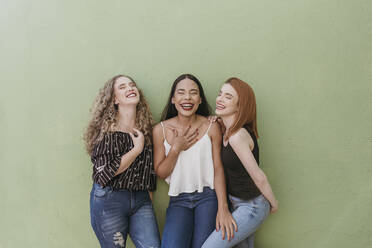 Woman Laughing against wall Stock Photo - Alamy