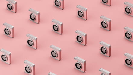 Three dimensional pattern of old-fashioned camera standing in rows against pink background - JPSF00045