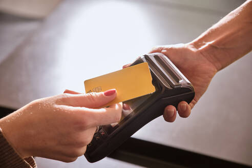 Woman making contactless payment at restaurant - AODF00314