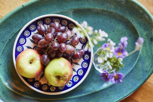 Bowl of fresh ripe grapes and apples with flower - SABF00061