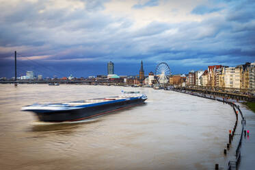 Germany, North Rhine Westphalia, Dusseldorf, River boat at high tide on the Rhine - FRF00922