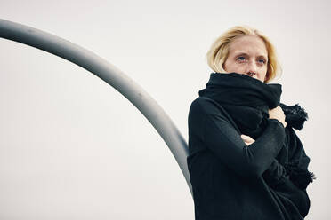 Blond woman with scarf against clear sky - UKOF00139