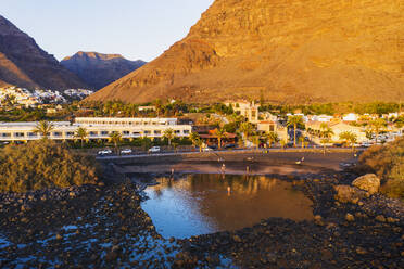 Spain, Valle Gran Rey, Drone view of town at edge of La Gomera island at dusk - SIEF10105