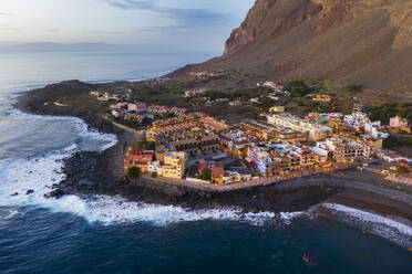 Spain, Valle Gran Rey, Drone view of town at edge of La Gomera island at dusk - SIEF10106