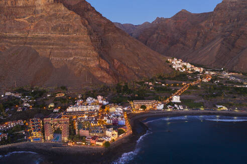 Spain, Valle Gran Rey, Drone view of town at edge of La Gomera island at dusk - SIEF10107