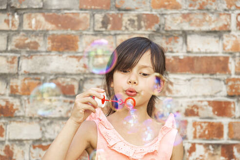 Child making soap bubbles - DRF01765