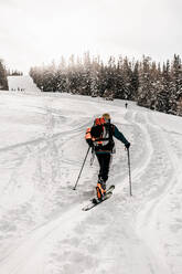 Caucasian senior man skiing on snow during vacation - DAWF01775