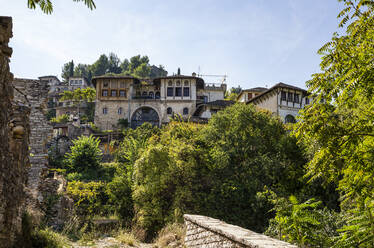 Old house behind trees against sky at Gjirokaster, Albania - MAMF01648