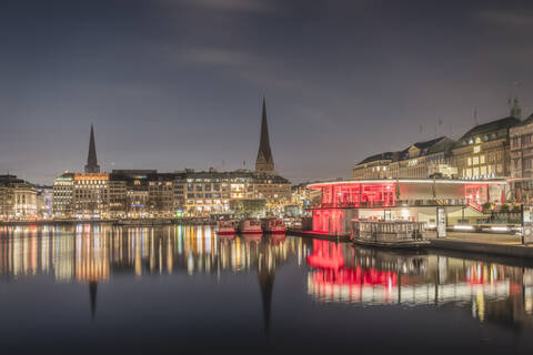 Germany, Hamburg, City architecture reflecting in Binnenalster lake at dawn stock photo