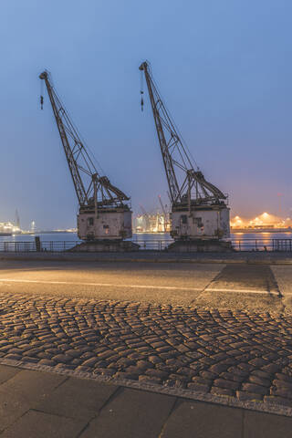 Germany, Hamburg, Altona, Cranes at harbor stock photo