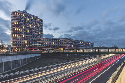 Germany, Hamburg, Amt fur Umwelt building exterior illuminated at dawn  stock photo