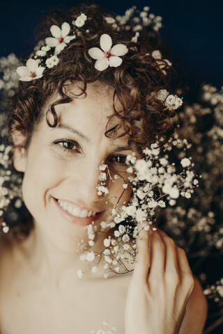 Smiling beautiful woman with white flowers in hair stock photo