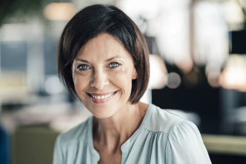 Smiling female entrepreneur in office stock photo