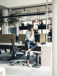 Female entrepreneur talking on telephone at office - JOSEF03750