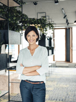 Confident businesswoman with arms crossed at office - JOSEF03756