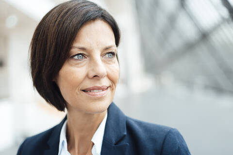 Thoughtful female entrepreneur looking at office stock photo