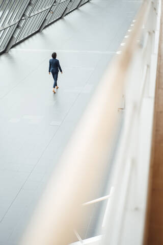 Businesswoman walking in corridor at office stock photo