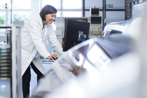 Female technician using computer in laboratory stock photo