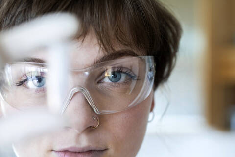 Close-up of female technician wearing eyeglasses working while standing in laboratory stock photo