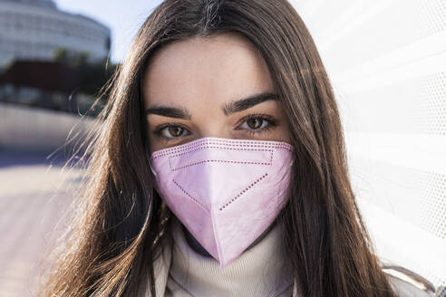 Teenage girl with protective face mask on sunny day - JRVF00291