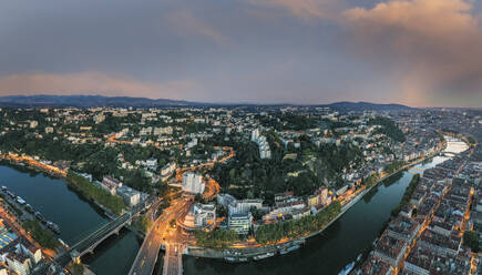 France, Auvergne-Rhone-Alpes, Lyon, Aerial panorama of riverside city at dusk - HAMF00860