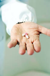 Doctor holding pills in hand - CAVF93453