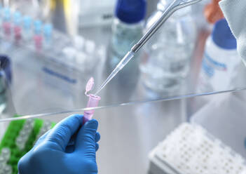 Scientist using pipette while doing research in laboratory - ABRF00831