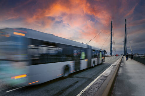 Germany, Nordrhein Westfalen, Dusseldorf, Bus crossing suspension bridge - FRF00929