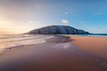 Malerische Landschaft der Kreidefelsen auf erstaunliche Playa de Covachos Sandstrand durch schäumende Meer von beiden Seiten gegen Sonnenuntergang Himmel in Kantabrien waschen gelegen - ADSF21083