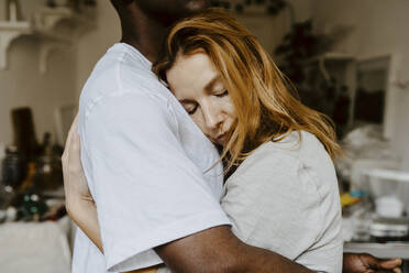 Son and mother embracing each other at home - MASF21951