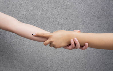 Studio shot of interconnected hands of two young women - JCCMF01313