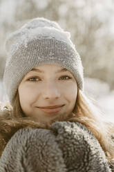 Portrait of beautiful teenage girl wearing knit hat smiling at camera - OJF00425