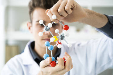 Male scientist working with molecular structure in laboratory - GIOF11581